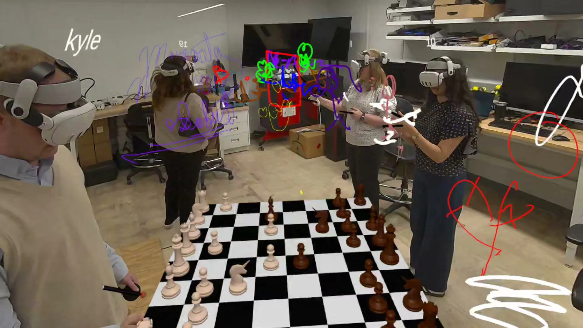 Lab members in mixed reality headsets around a virtual chessboard with sketches.