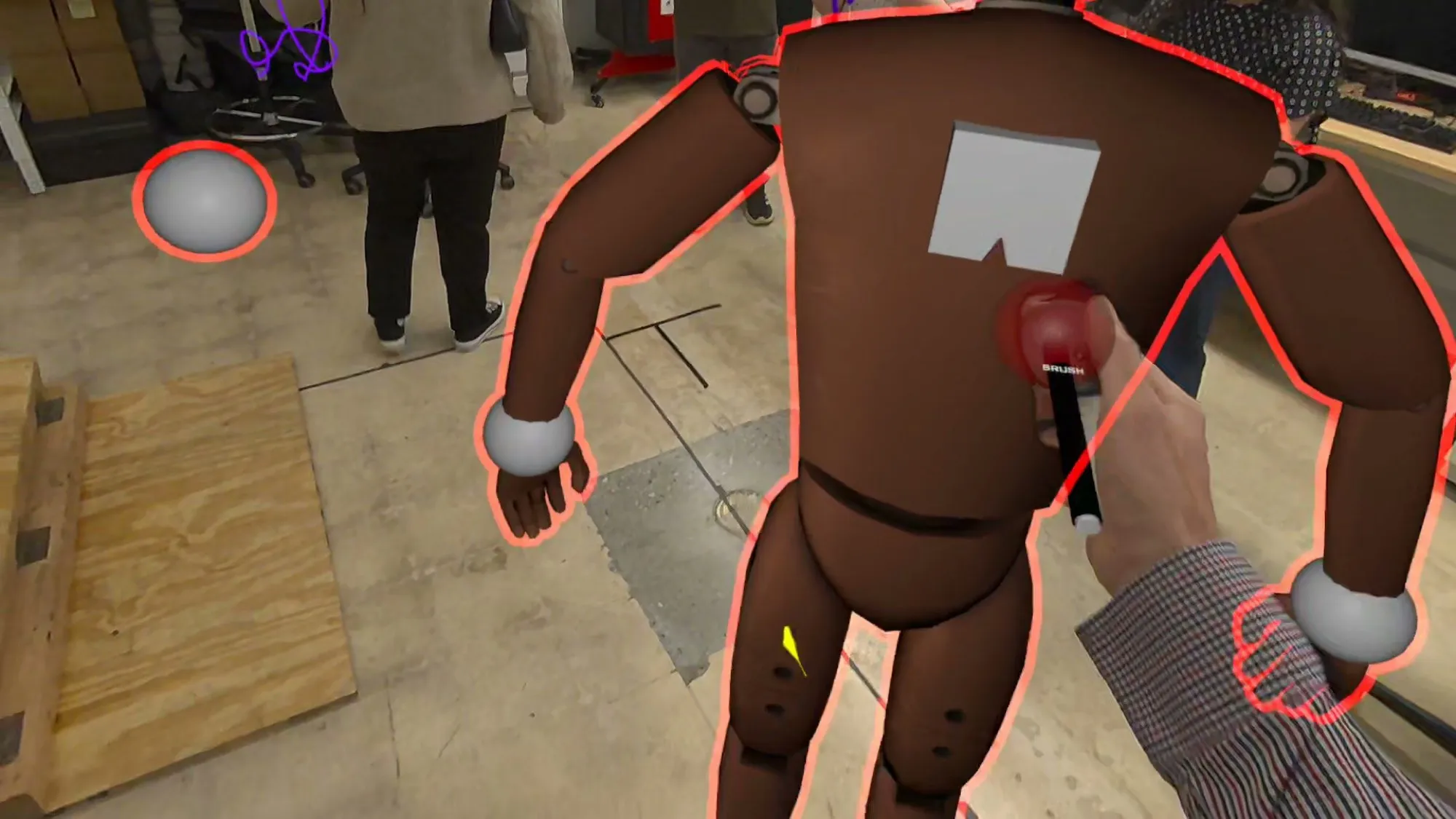 A posable virtual mannequin being adjusted with a controller.