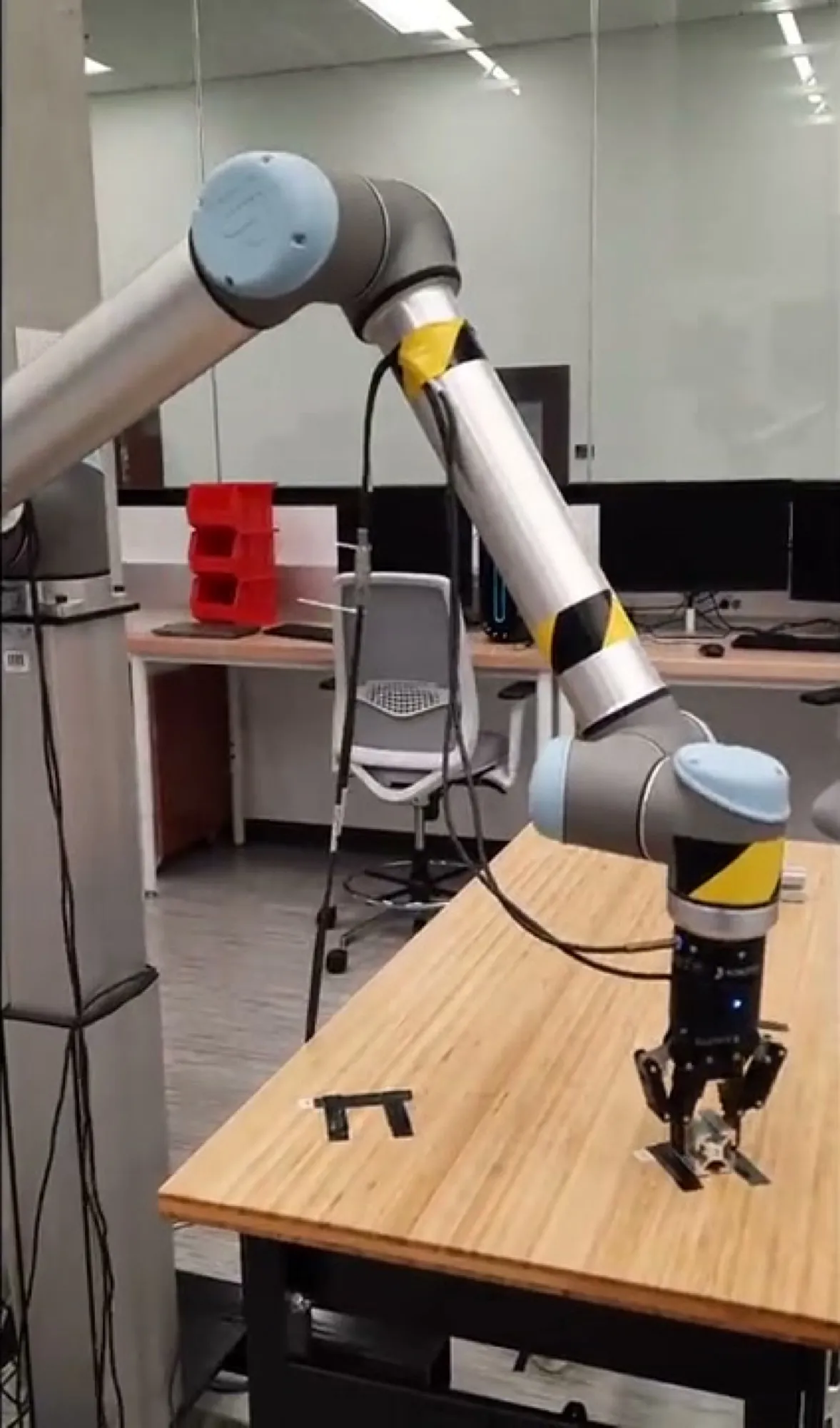 The physical UR10 robot arm on a workbench.