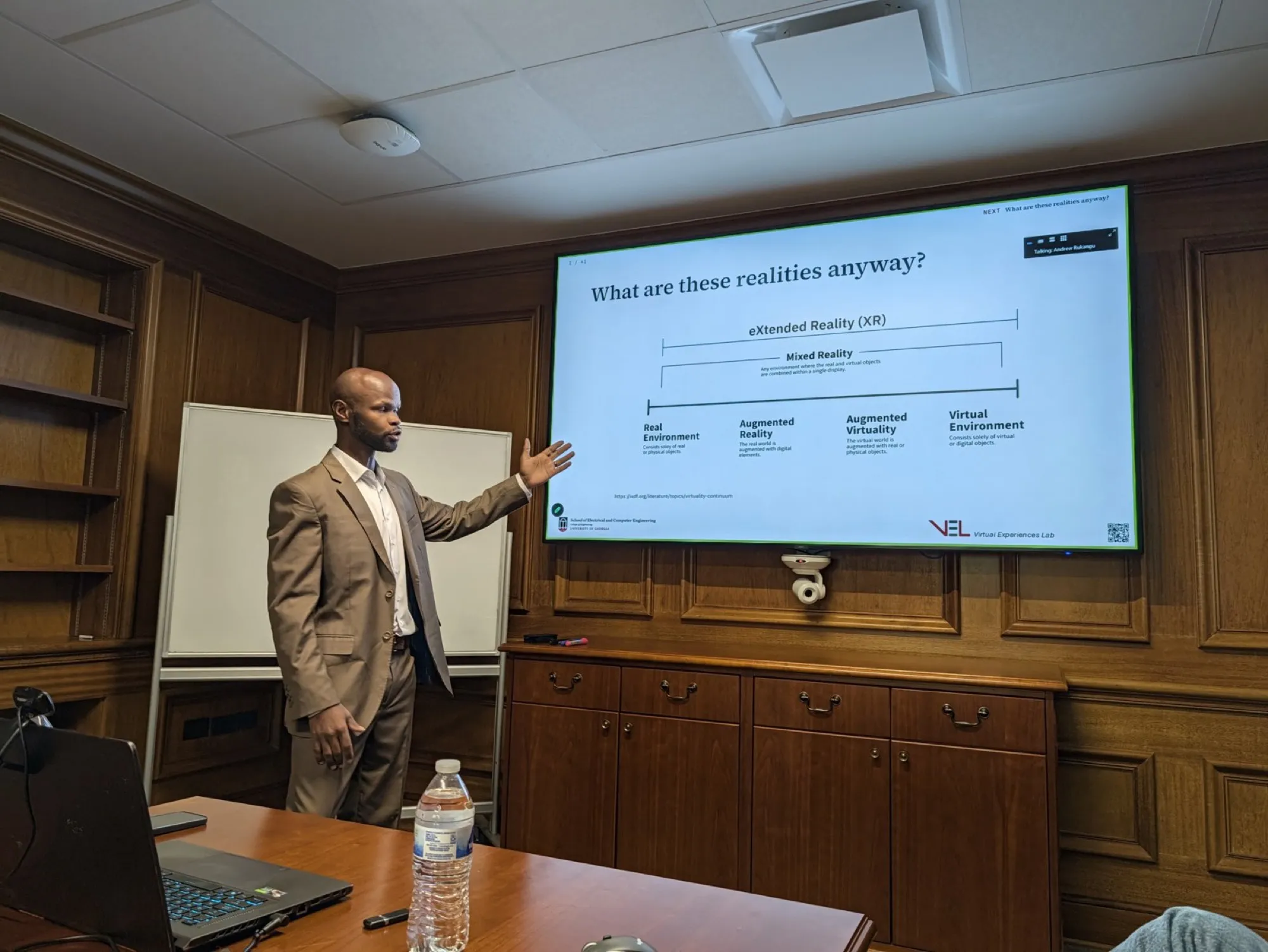 Andrew Rukangu presenting his dissertation defense.